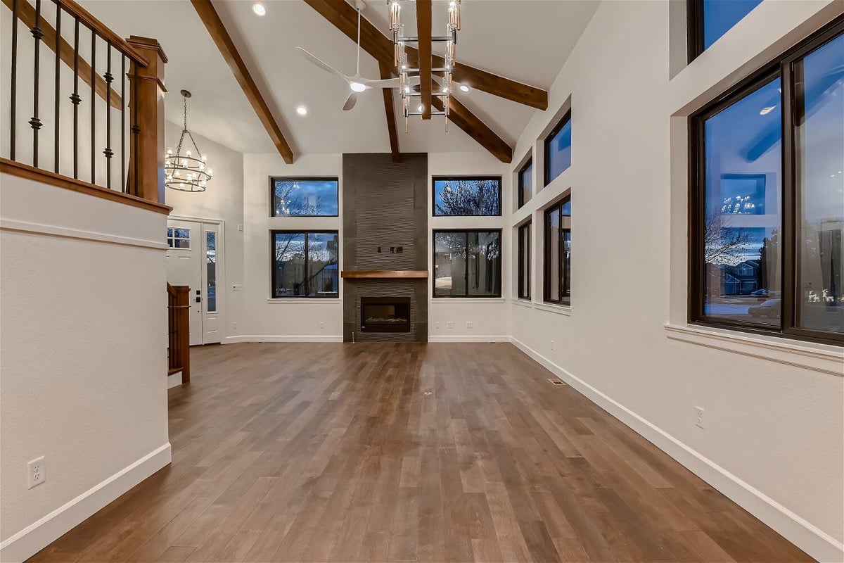 Modern living room featuring a fireplace corner, and sliding windows in a custom home by Sheffield Homes in Louisville, CO