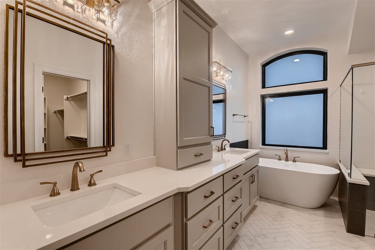 Premium bathroom with plenty of cabinets, dual vanities, and a freestanding tub in a Sheffield Homes home in Louisville, CO