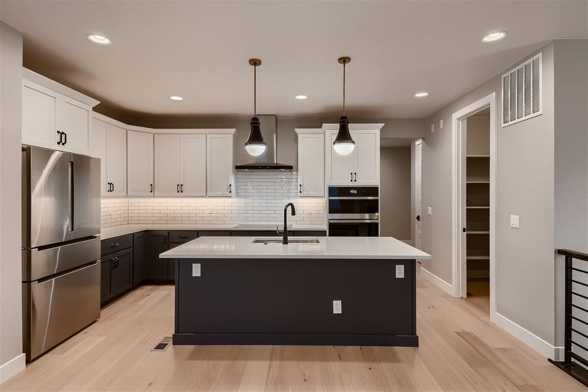 Open kitchen with an island, stainless steel appliances, and sleek cabinets in a Sheffield Homes home in Louisville, CO