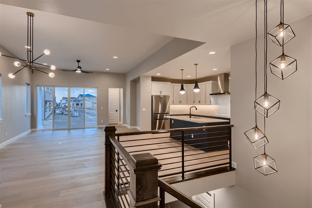 Upper living room with elegant pendant chandeliers and lighting details in a Sheffield Homes home in Louisville, CO