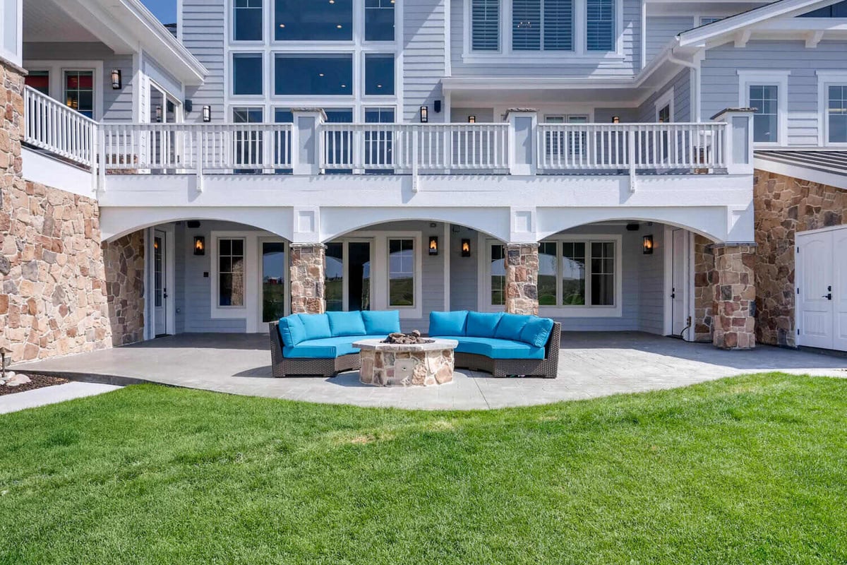 Beautiful backyard lawn with a sitting area in a large custom home built by Sheffield Homes in Parker, CO