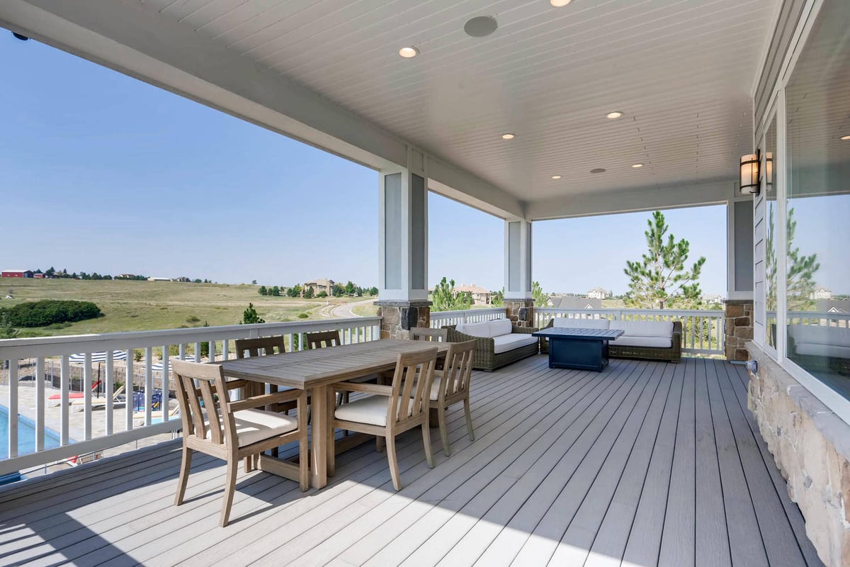 Deck with a wood table and chairs, a premium sofa set, and elevated outdoor views in a Sheffield Homes home in Parker, CO
