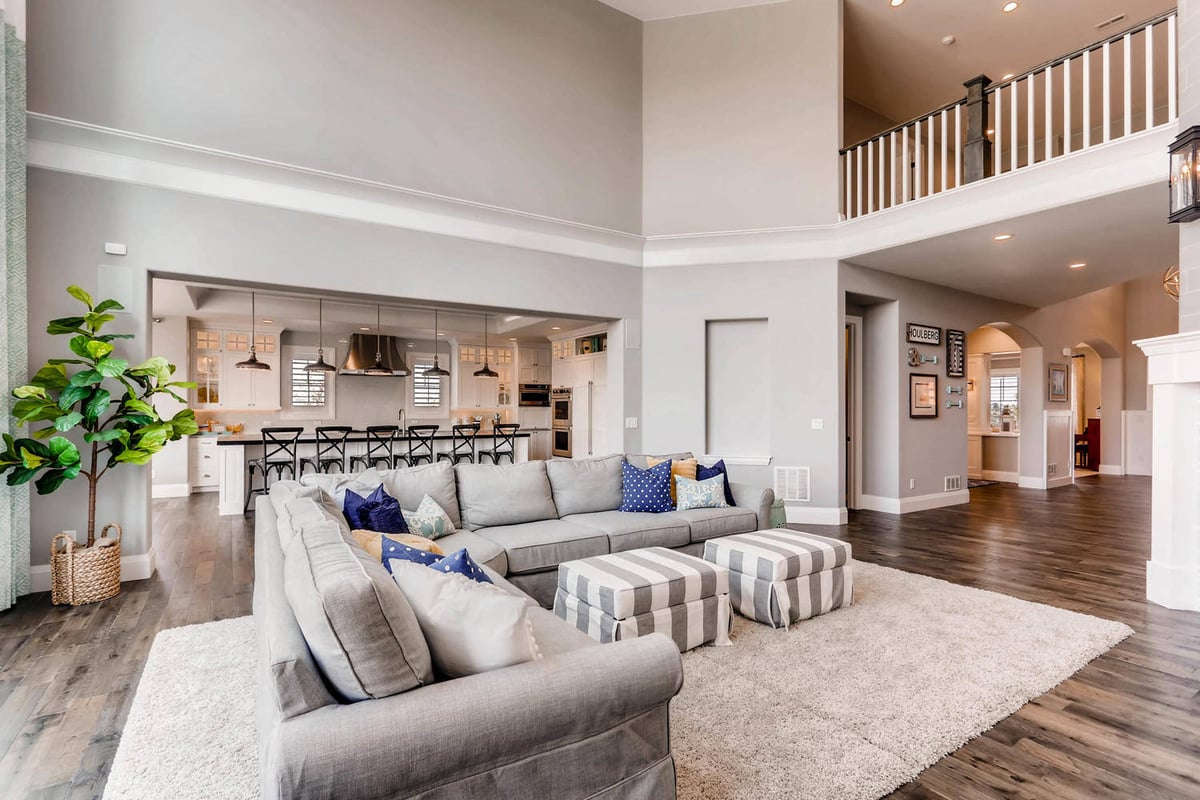 Family area with large sofas and two floor cushions on a floor rug in a custom home by Sheffield Homes in Parker, CO