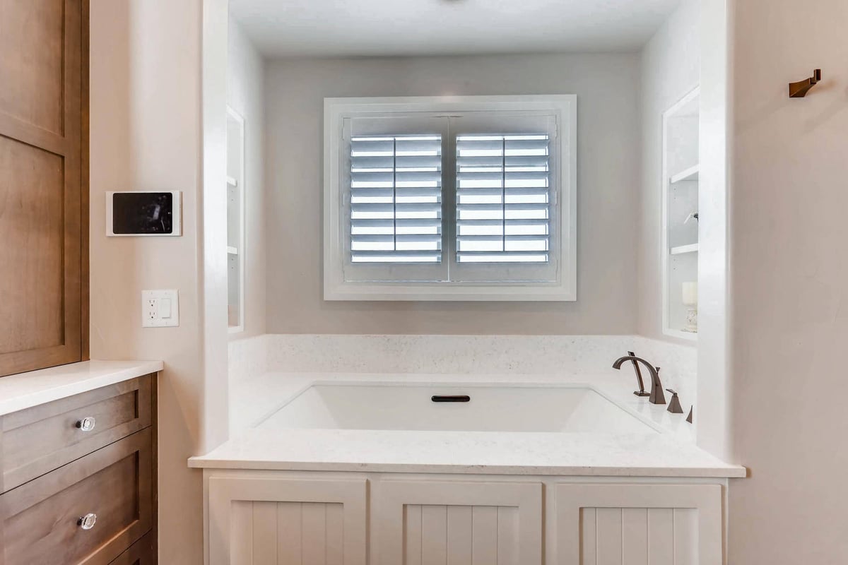Master bathroom details featuring a large bathtub with a sleek white finish in a Sheffield Homes home in Parker, CO