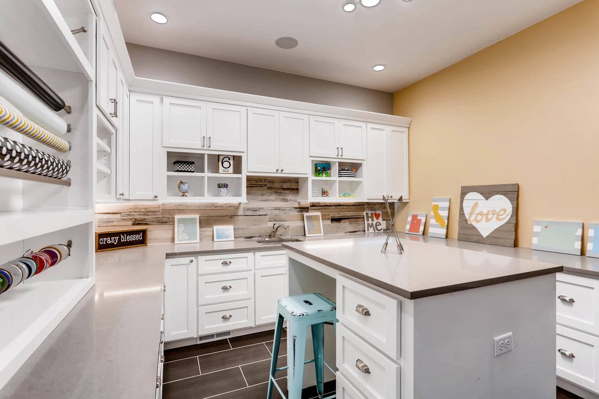 Recreation room with a central counter and various handcrafted decor pieces placed in a Sheffield Homes home in Parker, CO
