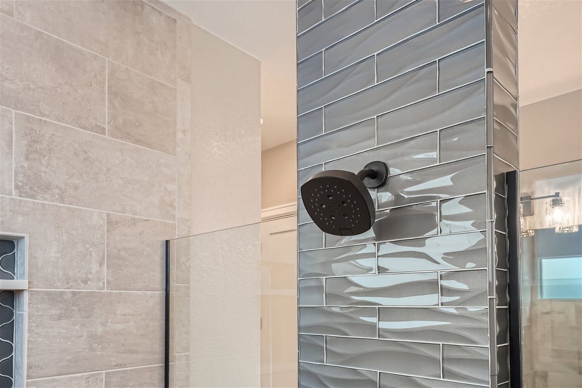 Closeup wall-mounted shower in a shower room of a custom home bathroom by Sheffield Homes in Superior, CO