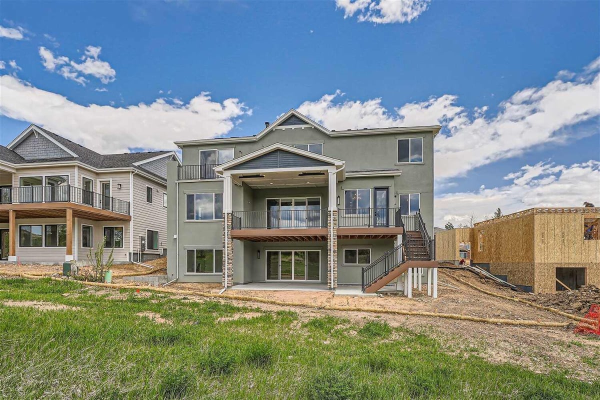 Exterior rear view of a large custom home with a backyard by Sheffield Homes in Superior, CO