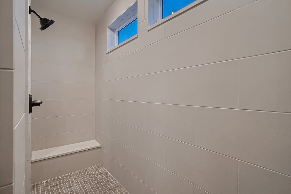 Bathroom with close-up details of shower room with wall tiling and windows in a Sheffield Homes home in Superior, CO