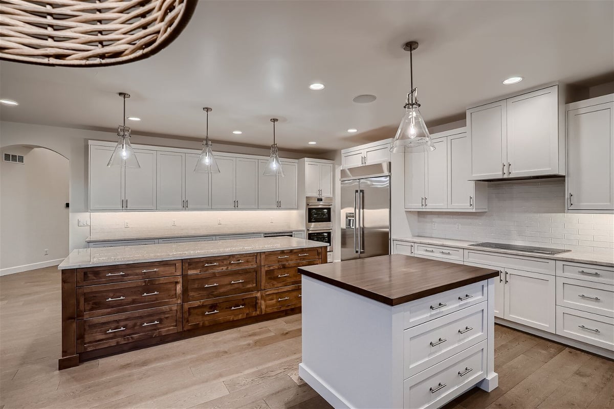 Kitchen with a wooden cabinetry counter, a mini counter, and sleek white cabinets in a Sheffield Homes home in Superior, CO
