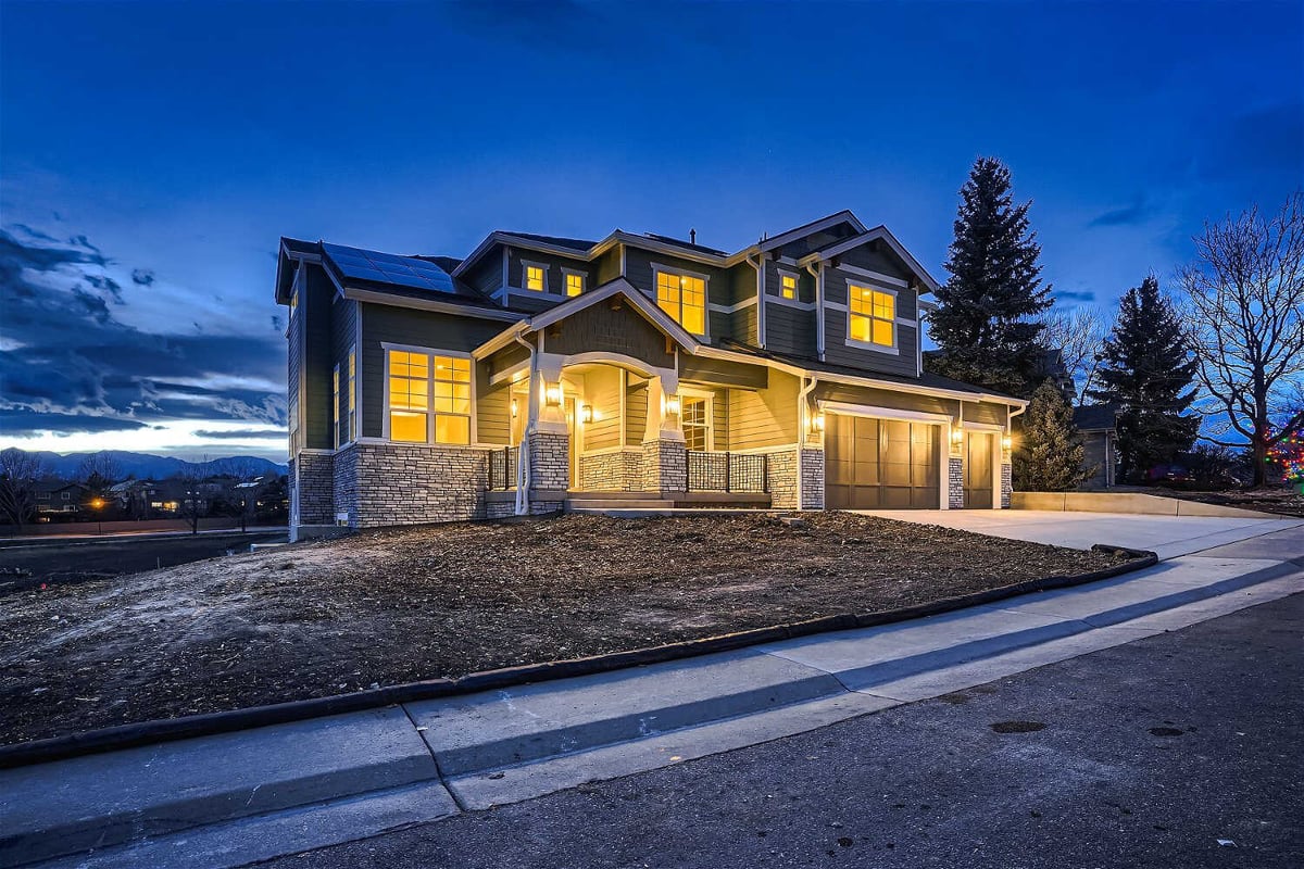Long exterior front shot of a custom home with modern design and a paved driveway - by Sheffield Homes in Superior, CO