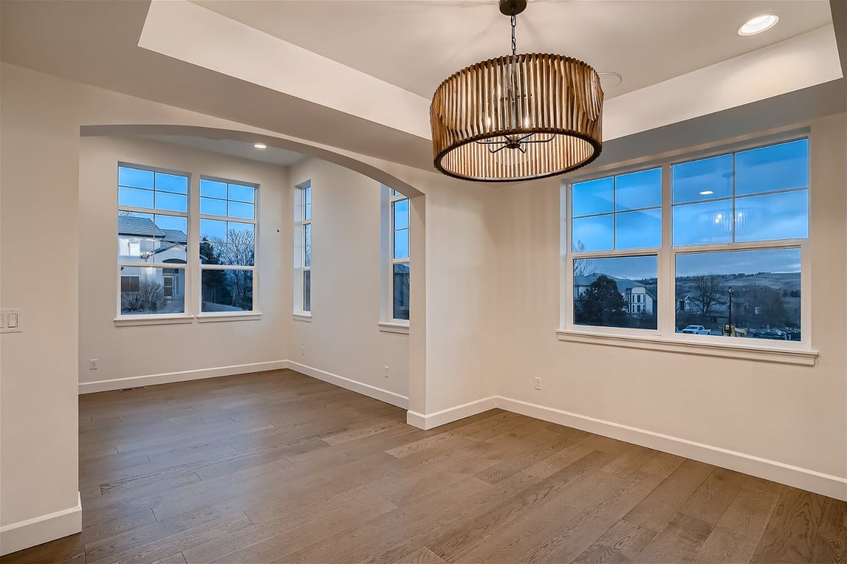 Modern dining room with an elegant light fixture and sliding windows in a custom home by Sheffield Homes in Superior, CO(1)