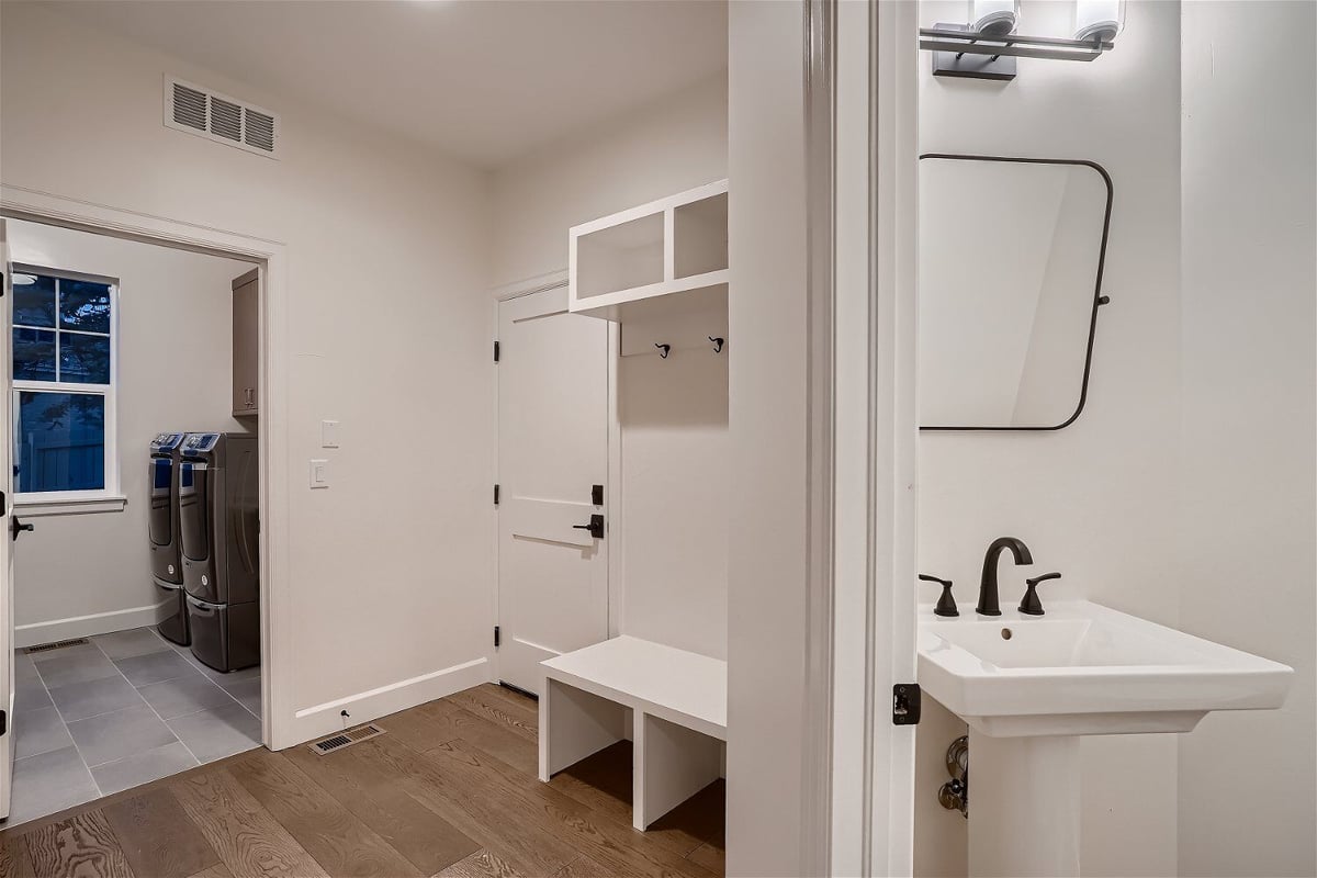 Mudroom next to the laundry room with space-efficient cabinets and footwear storage in a Sheffield Homes home in Superior, CO