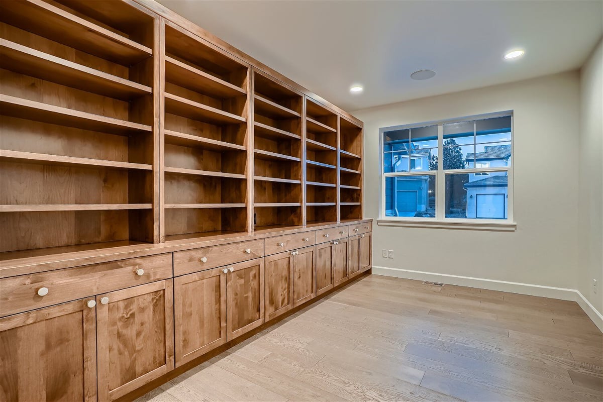 Office with spacious wall-mounted closets and a sliding window for outside views in a Sheffield Homes home in Superior, CO