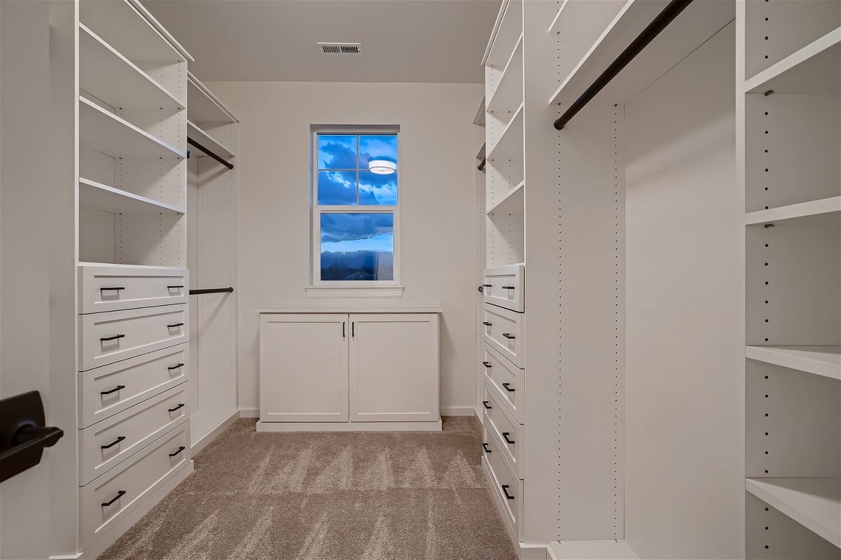 Primary bedroom with a wall-mounted closet offering ample space and a front window in a Sheffield Homes home in Superior, CO