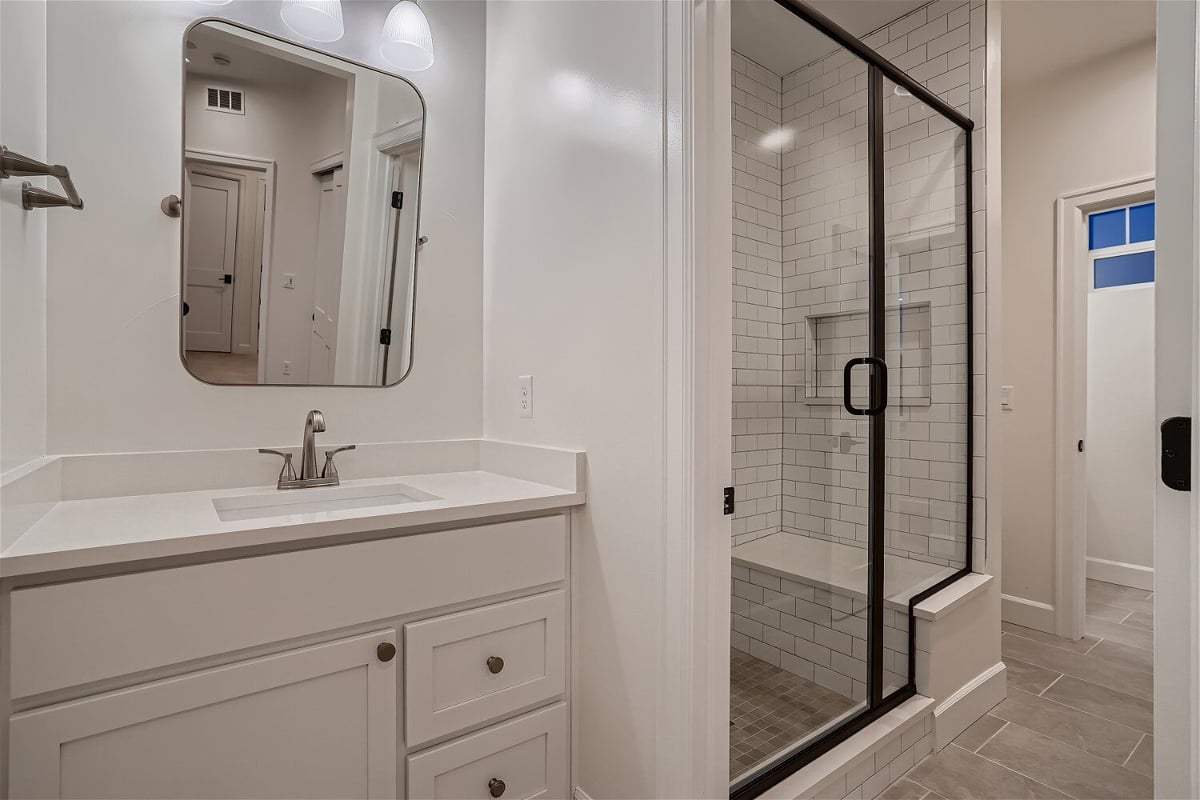 Second-floor Jack and Jill bathroom with a shower enclosure, and a modern vanity in a Sheffield Homes home in Superior, CO