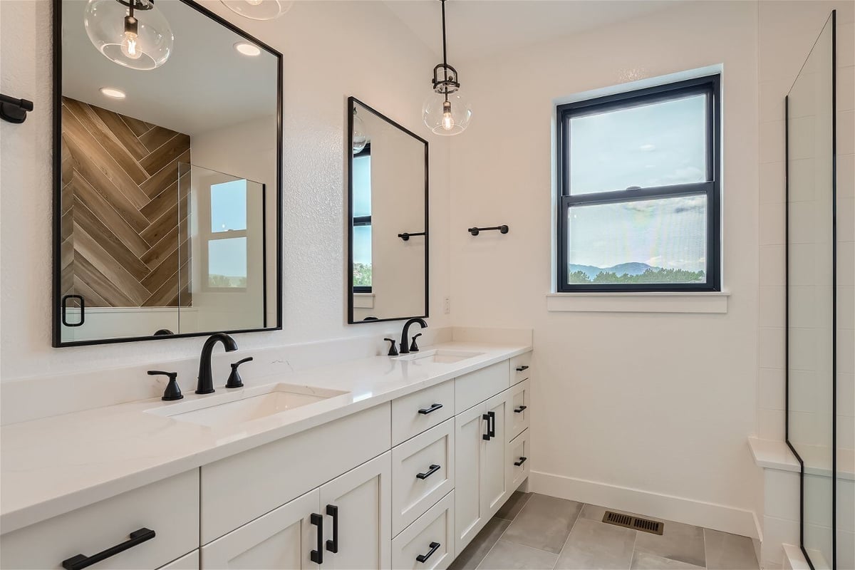 Bathroom featuring a modern vanity with white cabinetry, and black faucet fixtures in a Sheffield Homes home in Superior, CO