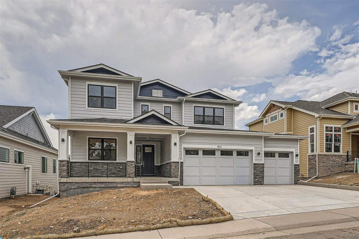 Daylight exterior front view of a custom home with an outdoor yard by Sheffield Homes in Superior, CO