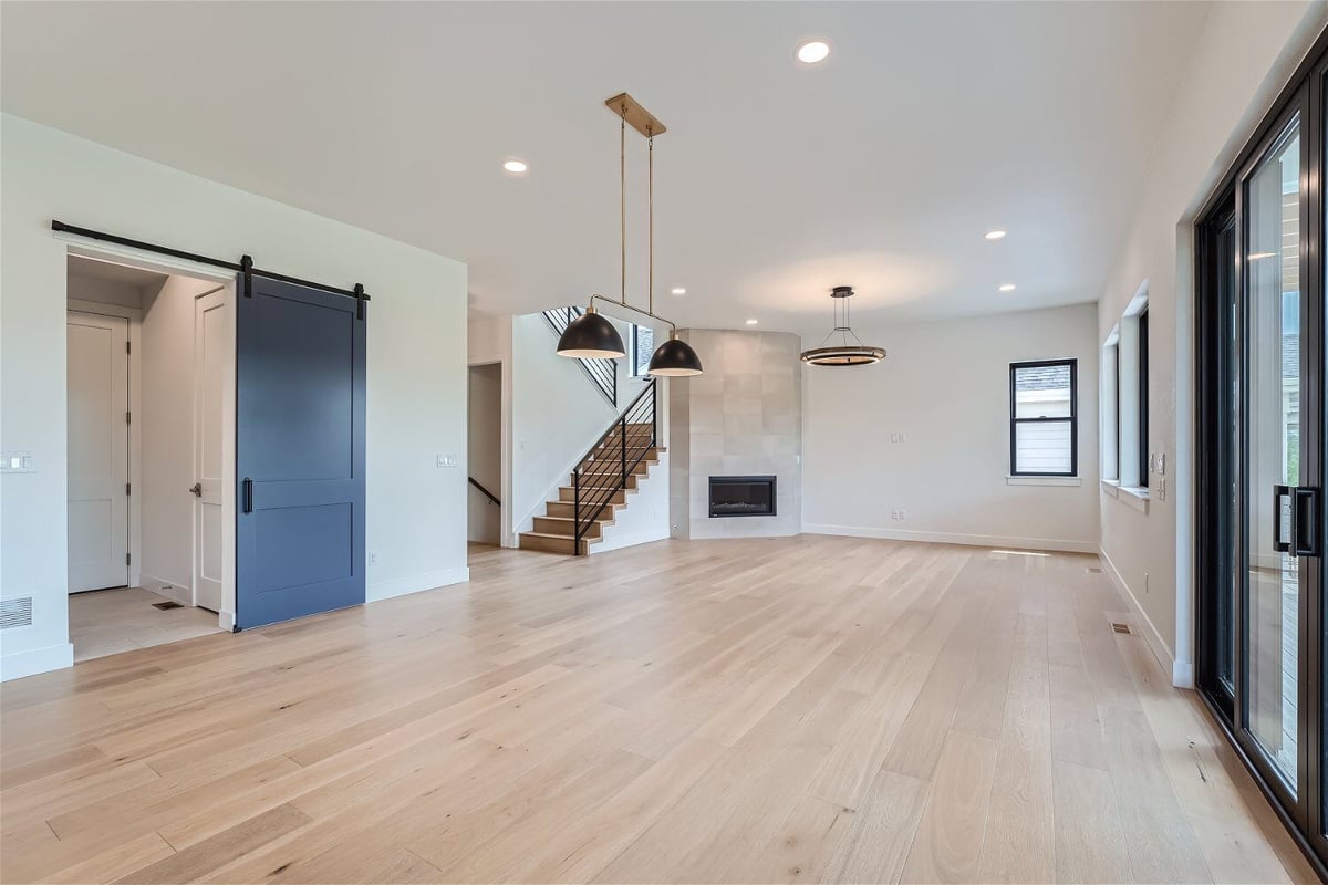 Dining room with wood texture flooring, an access door, and a pendant light fixture in a Sheffield Homes home in Superior, CO