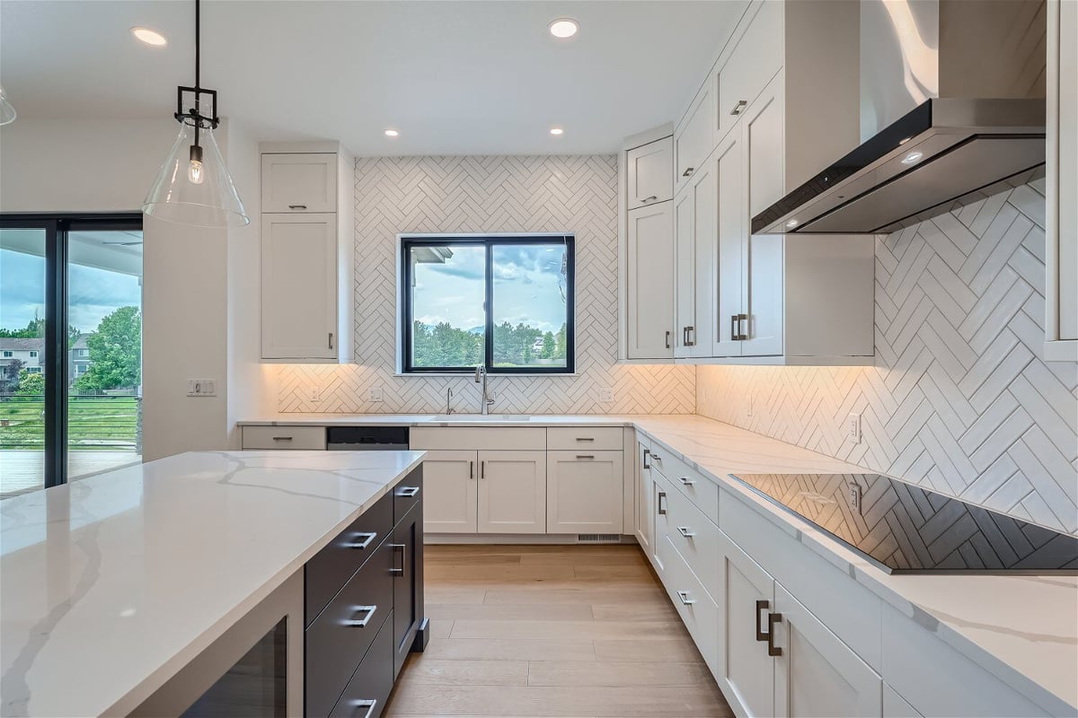 Inside the modern open kitchen featuring an island and main kitchen counter in a Sheffield Homes home in Superior, CO