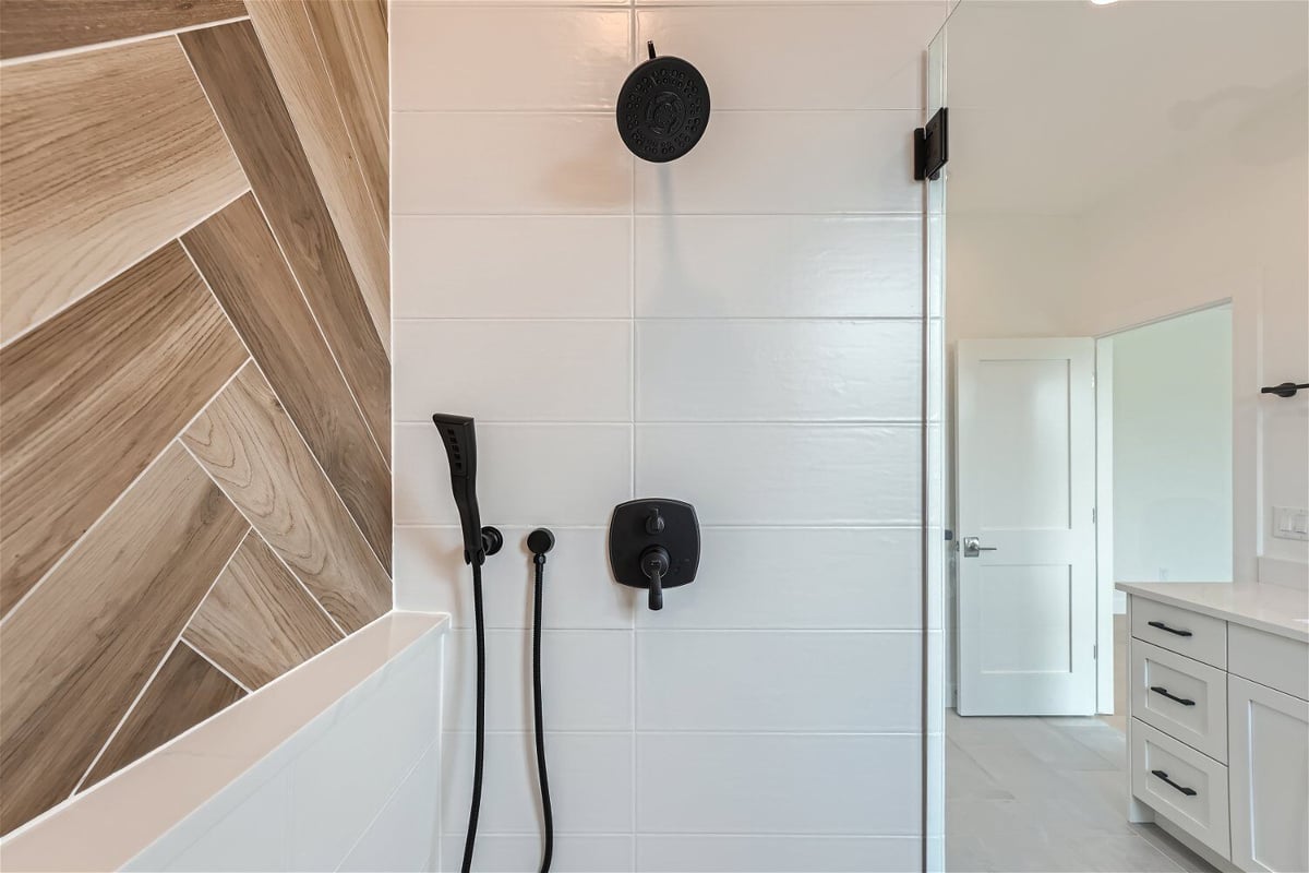 Inside the second-floor primary bathroom shower room, featuring black fixtures, in a Sheffield Homes home in Superior, CO