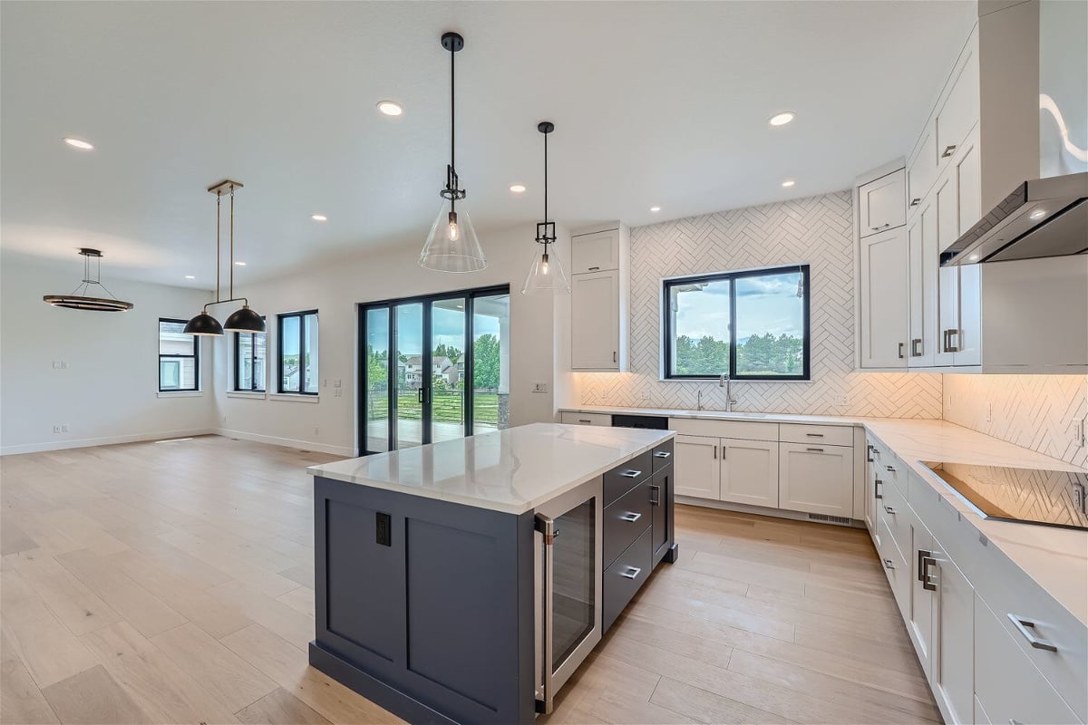 Kitchen cabinetry with a centred island and pendant lighting fixture over it in a Sheffield Homes home in Superior, CO
