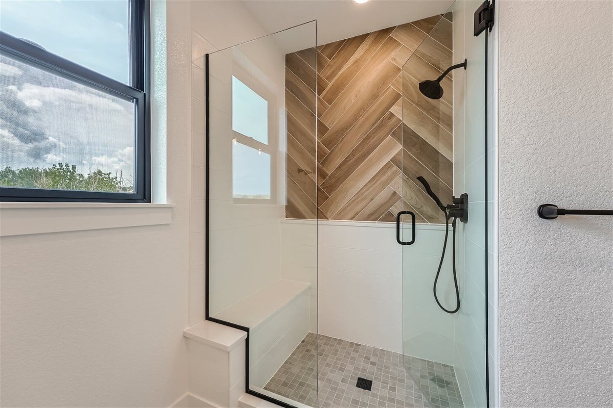 Second-floor primary bathroom with a shower room featuring black shower fixtures, in a Sheffield Homes home in Superior, CO