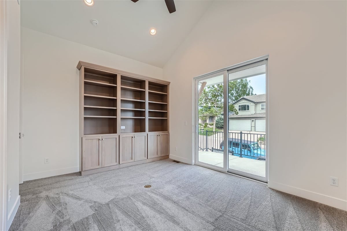 Bedroom with carpet flooring, a wall-mounted closet, and a door leading to the balcony in a Sheffield Homes home, Superior, CO