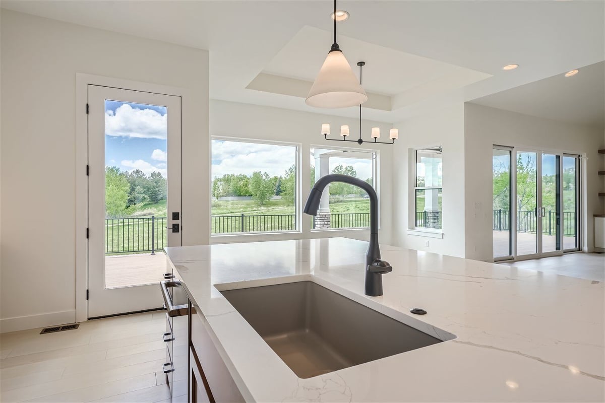 Close-up of the kitchen island featuring a black sink faucet detail in a custom home by Sheffield Homes in Superior, CO