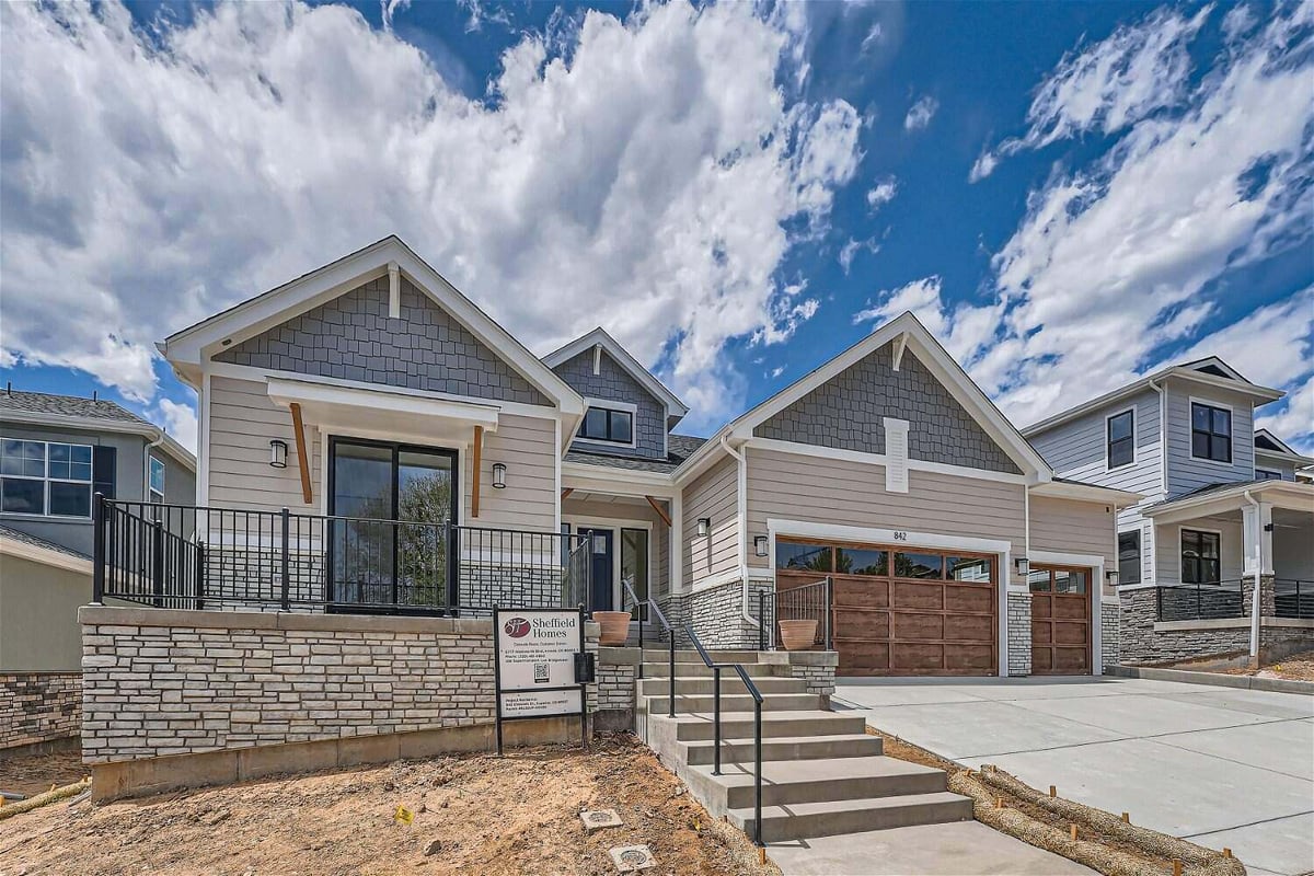 Daylight exterior front shot of a home with a stair pathway leading to the main door, by Sheffield Homes in Superior, CO