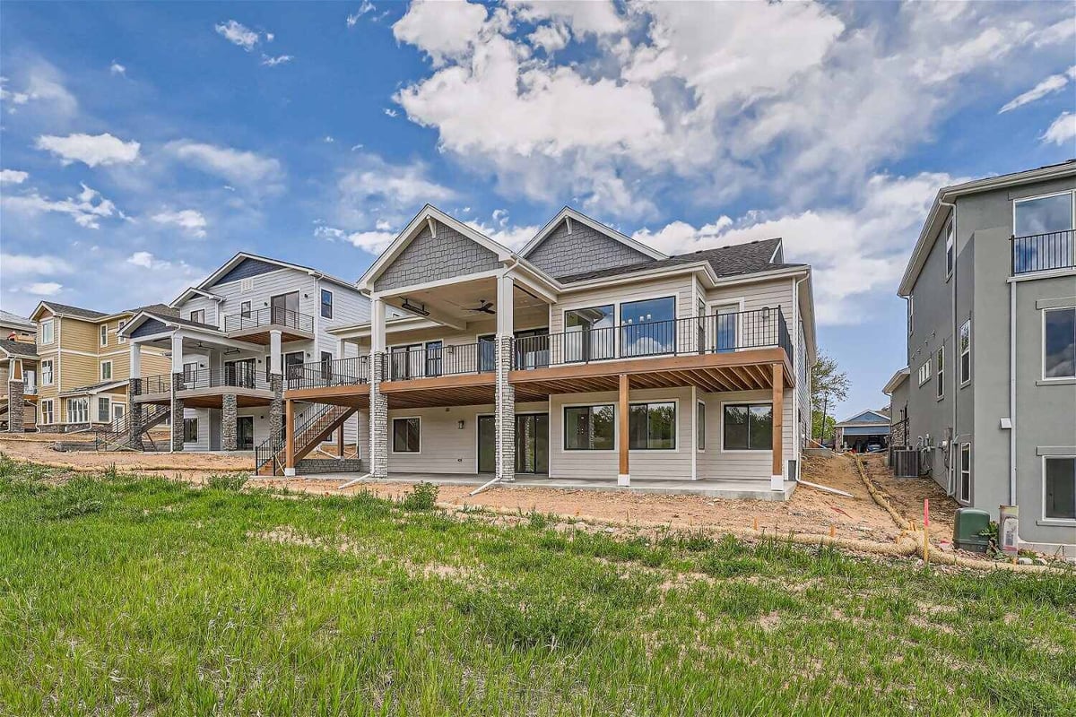 Daylight exterior rear view of a custom home with a backyard, built by Sheffield Homes in Superior, CO