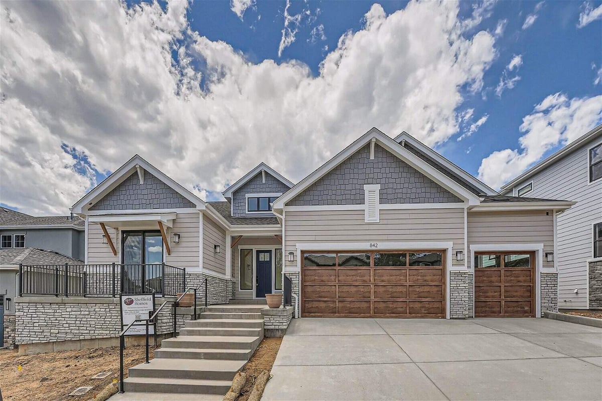 Exterior front view of a large custom home with a stair pathway leading to the main door, by Sheffield Homes in Superior, CO