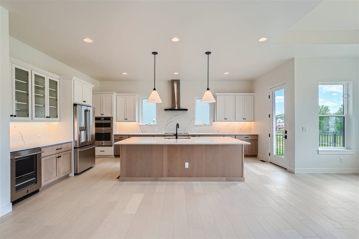 Front view of the open kitchen featuring a central island and main stove counter in a Sheffield Homes home in Superior, CO
