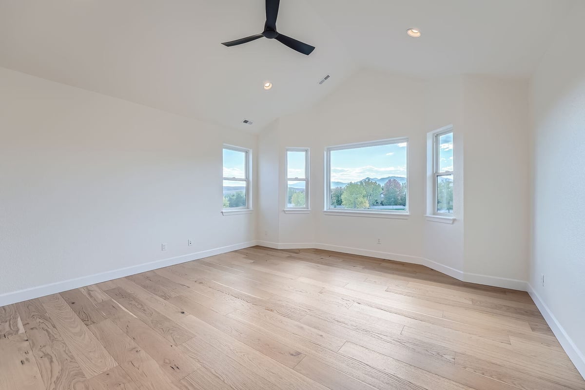 Bright and airy primary bedroom with hardwood flooring, Sheffield Homes, Denver, CO