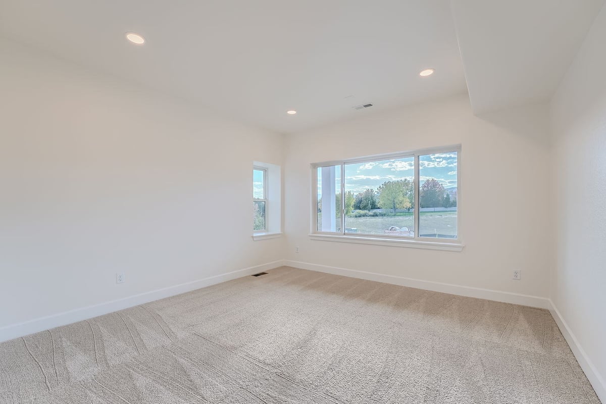 Bright lower-level bedroom with large windows, custom home by Sheffield Homes, Denver, CO