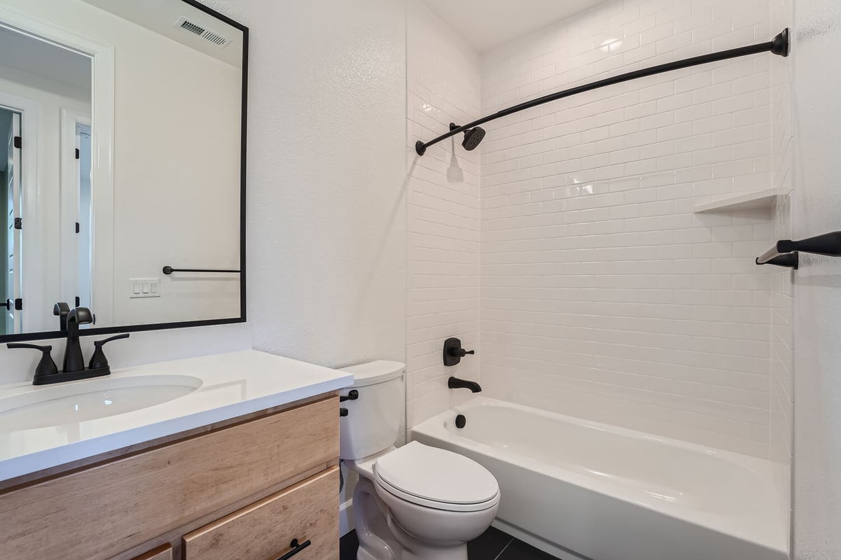 Contemporary bathroom with white tile and matte black fixtures, Sheffield Homes, Denver, CO