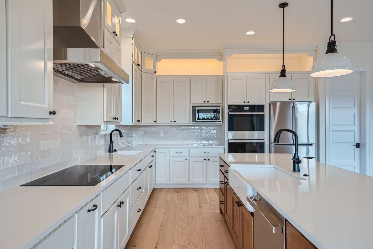 Contemporary kitchen in a Sheffield Homes custom home, showcasing an island and stainless steel appliances