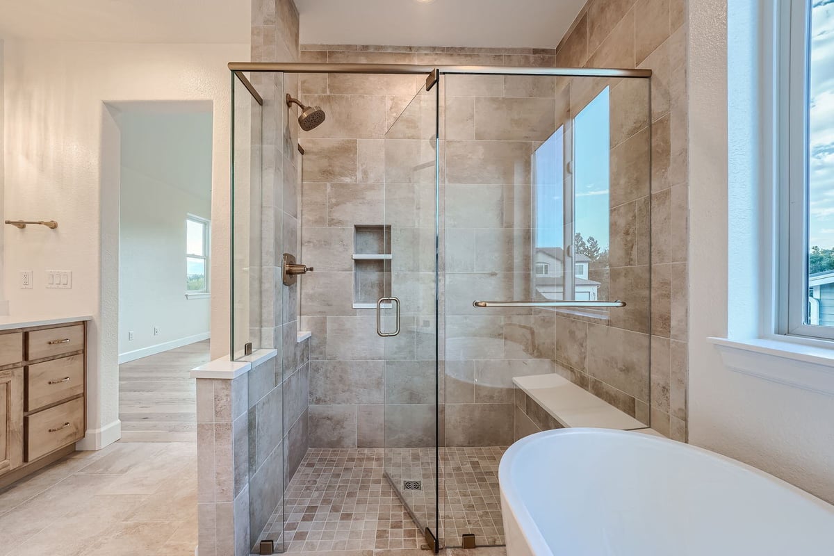 Elegant primary bathroom with glass shower and modern tile work, Sheffield Homes, Denver, CO