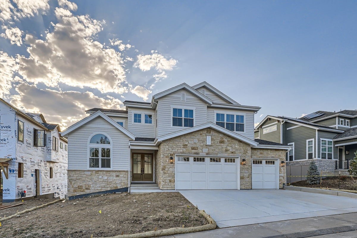 Front view of a custom-built home by Sheffield Homes in Denver, CO, featuring a stone and siding facade