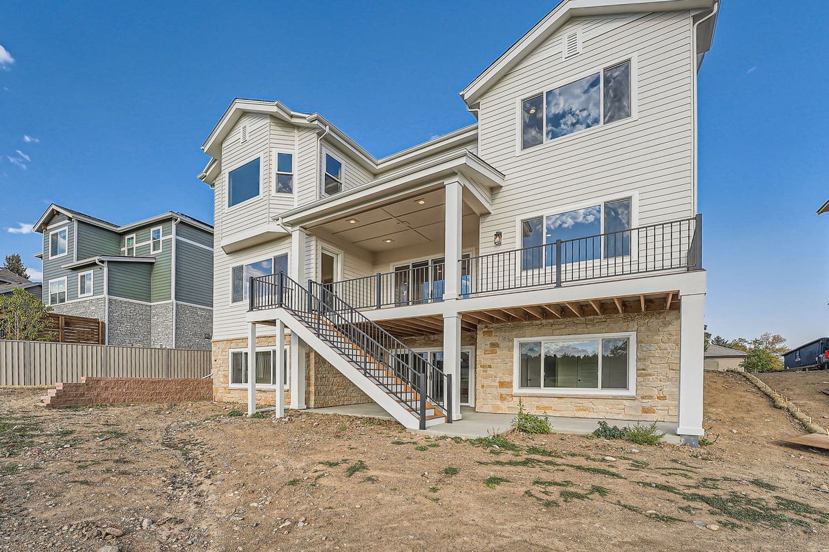 Full rear exterior showcasing the deck and stonework, custom home by Sheffield Homes, Denver, CO