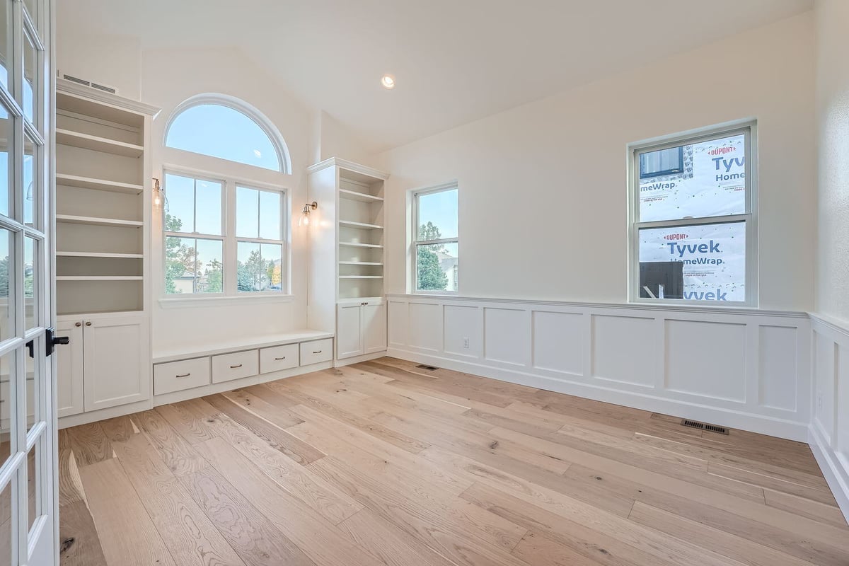 Home office in a Sheffield Homes custom home in Denver, CO, with built-in shelves and natural light