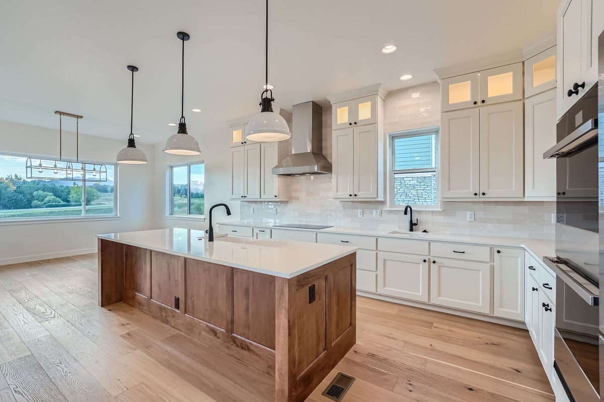 Kitchen in a custom Denver home by Sheffield Homes, featuring pendant lighting over the island