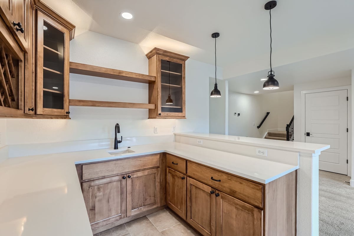 Modern lower-level wet bar with open shelving in a Sheffield Homes custom home, Denver, CO