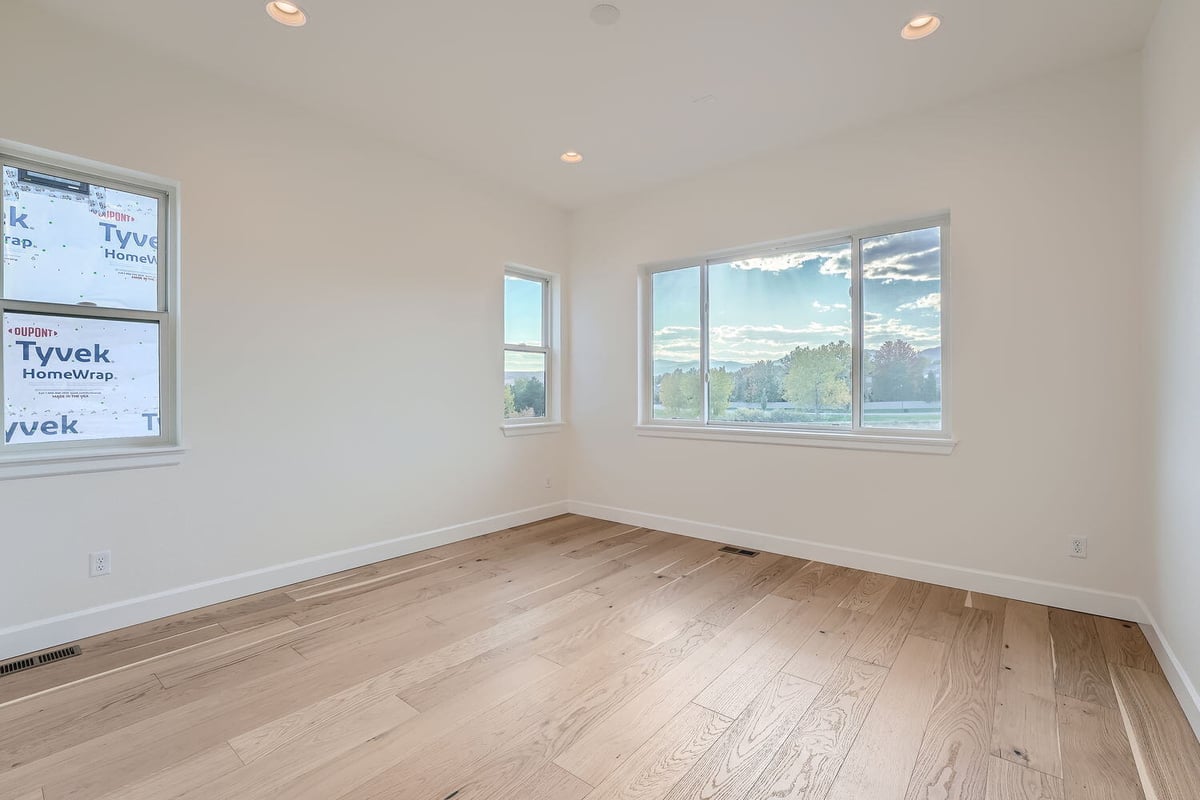 Office room in a custom home by Sheffield Homes in Denver, CO, featuring built-in shelves and storage drawers