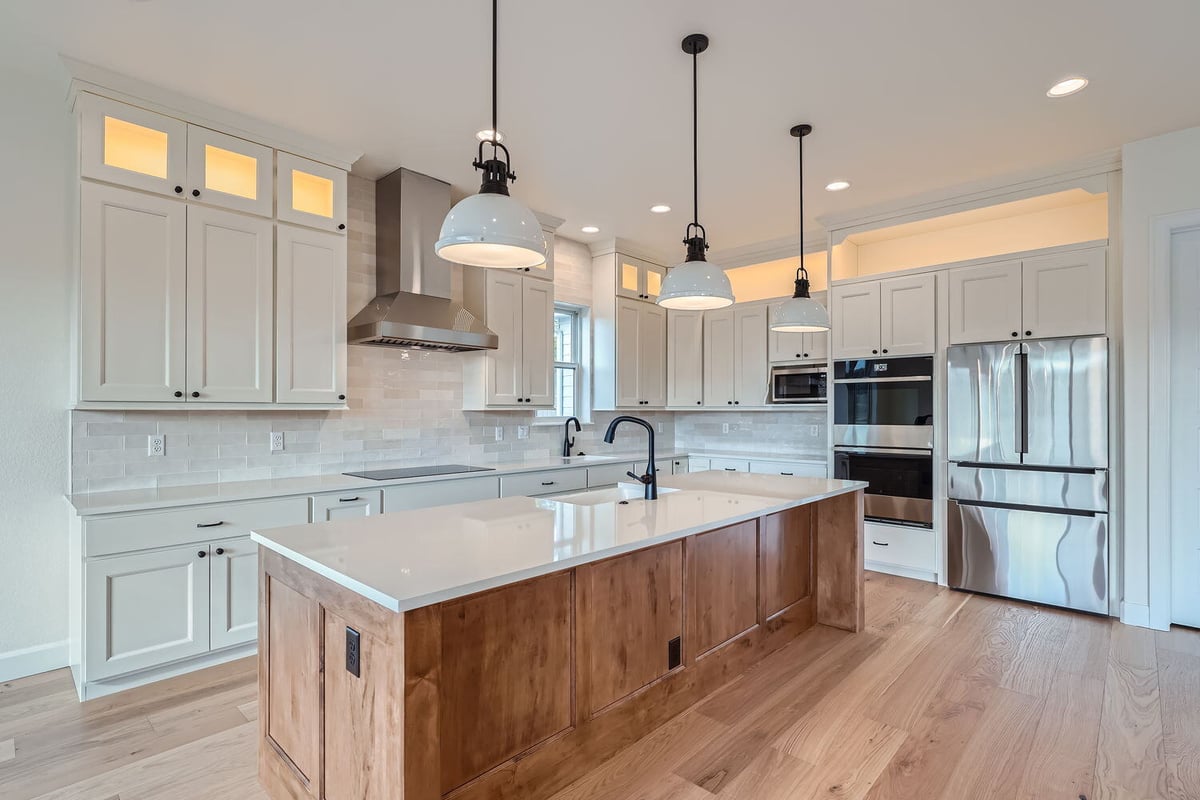 Open-concept kitchen with stainless steel appliances and wood accents, Sheffield Homes, Denver, CO