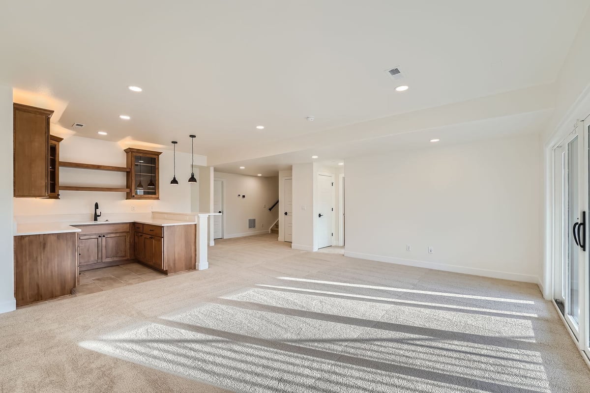 Open-concept lower-level family room with custom wood cabinetry, Sheffield Homes, Denver, CO
