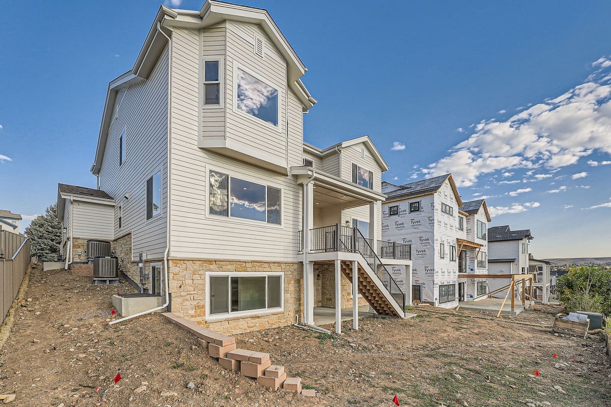 Rear exterior view of a custom home by Sheffield Homes with stone accents, Denver, CO