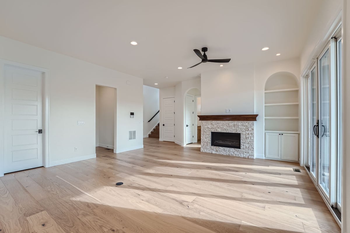 Well-lit living room in a Denver custom home by Sheffield Homes, featuring natural light and neutral tones