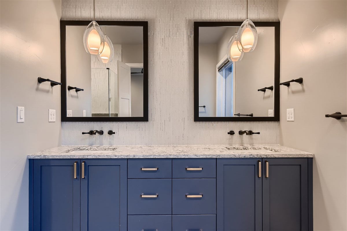 Dual vanity with modern fixtures in the primary bathroom of a custom Sheffield Homes residence, Denver, CO