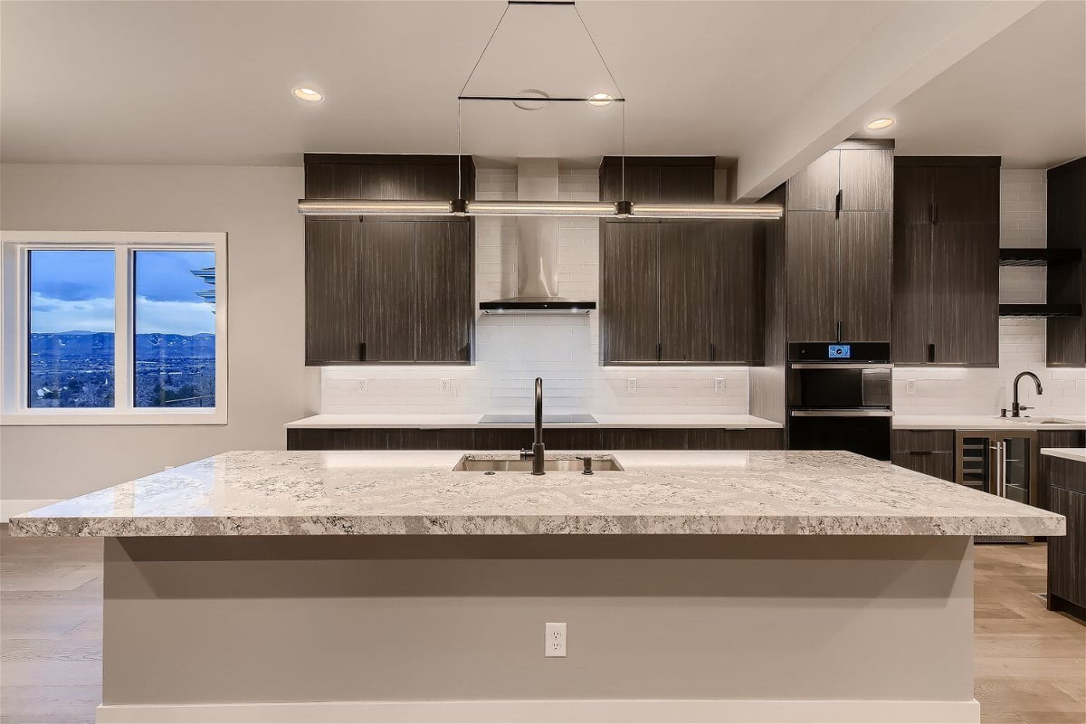 Kitchen view with dark cabinetry and built-in appliances in a Sheffield Homes custom home in Denver, CO