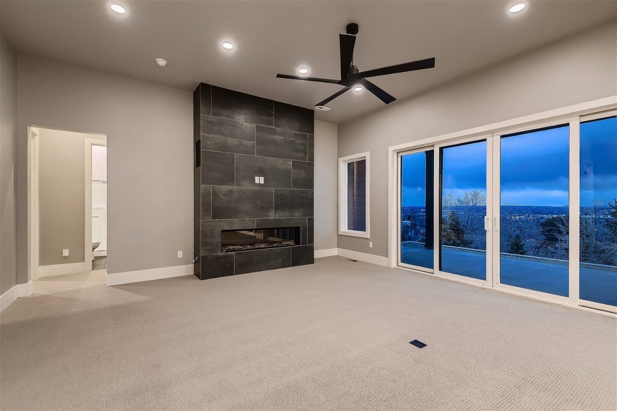 Lower-level family room with modern fireplace in a custom-built home by Sheffield Homes, Denver, CO